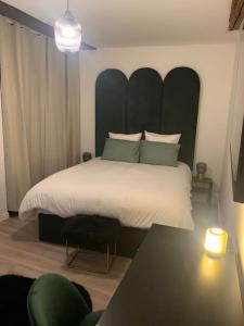 第戎Appartement velouté的一间卧室配有一张大床和大床头板