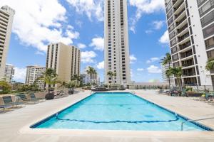 檀香山Warm Aloha Vibes, Mountain Views, Short Walk to Beach, and Free Parking的一座大型游泳池,其建筑背景为: