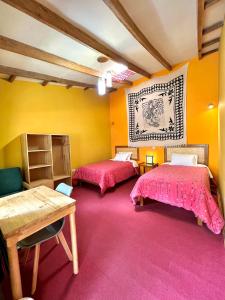 皮萨克皮萨克印加宾馆的黄色墙壁客房的两张床