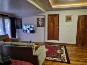 马塔兰Suci's Friendly Appartment的带沙发和木门的客厅