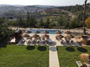 马勒哈查米萨Gordonia Private Hotel的庭院内一个带椅子和遮阳伞的游泳池