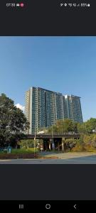 新山High class condominium 3rm Bukit Indah Johor pool gym的一座建筑,有高大的建筑背景