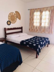 卡诺格布拉达Manitu Flat Canoa Quebrada的一间卧室设有两张床和窗户。