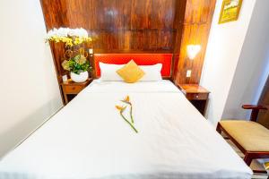 胡志明市Bonka Hotel Luxury Quận 5 HCM的卧室配有白色床和红色床头板