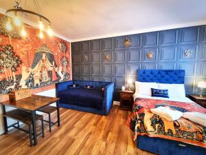 沃特福德Ricky Road Guest House - "Wizard Studio Room" Available to Book Now的一间卧室配有蓝色的床和蓝色的沙发