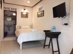 琅勃拉邦坎空美景旅馆的卧室配有一张床,墙上配有电视