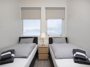 凯夫拉维克KEF Guesthouse by Keflavík airport的带2扇窗户的客房内的2张床
