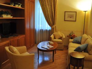 罗马德亚套房罗马酒店的客厅配有沙发和桌子