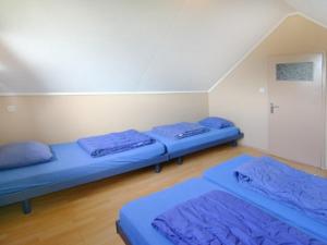 卡德赞德Jadi的配有蓝色床单的客房内的两张床