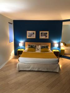 蒙彼利埃Couette et Café的一间卧室配有一张带蓝色墙壁的大床
