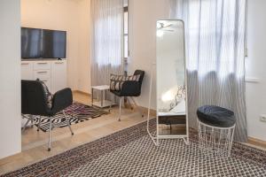 班贝格艾姆道姆酒店的客厅配有两把椅子和镜子