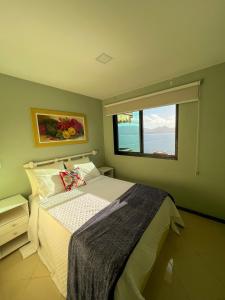 安格拉杜斯雷斯Apartamento Porto Real Resort (11.1 402) com vista panorâmica的一间卧室设有一张床和一个大窗户