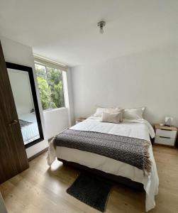 萨瓦内塔Sabaneta 22的白色的卧室设有床和大窗户