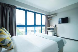 新加坡Harbour Ville Hotel的酒店客房设有一张床和一个大窗户