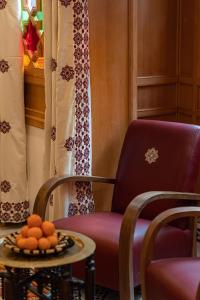 马拉喀什阿拉比庄园酒店的一间房间,配有椅子和一张桌子,上面有橙子