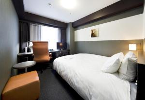 滨松滨松大和鲁内酒店的酒店客房配有一张床、一张书桌和一台电脑