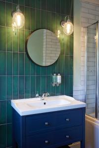 莱斯特Castle Hotel by Chef & Brewer Collection的浴室设有蓝色水槽和镜子