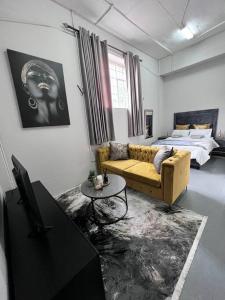 约翰内斯堡`Luxury Cosy City Apartment的客厅配有沙发和1张床