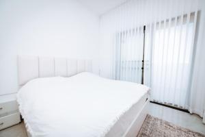 恰斯林אירוח בגולן的白色的卧室设有床和窗户