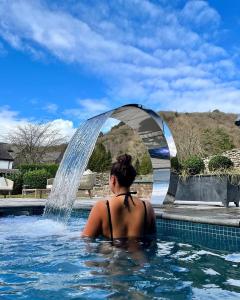 纽比桥天鹅Spa酒店的喷泉游泳池里的女人