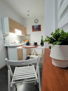 希隆斯克地区佩卡雷Studio Piekary 1-go Maja的厨房配有白色橱柜和桌椅