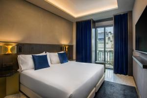 巴塞罗那杰拉德室友酒店的一间卧室设有一张大床和一个大窗户