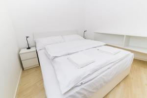 布拉迪斯拉发City Castle Apartments Free Parking的白色的床、白色床单和枕头