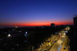 新德里Staybook Hotel Aira, Paharganj, New Delhi Railway Station的夜视城市街道,欣赏日落