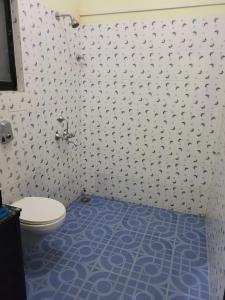 科尔瓦Sunshine Park Homes的一间带卫生间的浴室,铺有蓝色地板。