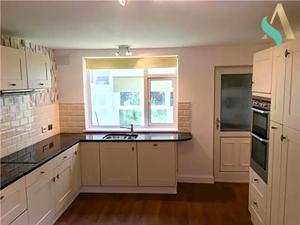 比林汉姆South View TSAC的厨房配有白色橱柜和窗户。