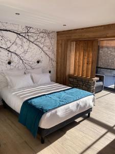 昂塞勒Appart Hôtel Le JAS的卧室配有一张挂在墙上的树壁床。