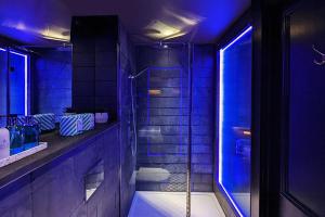 利兹The Bells - Luxury Serviced Apartments的带淋浴和浴缸的紫色浴室