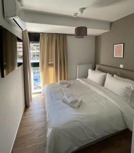 雅典Niarchos apartment III的卧室设有一张白色大床和一扇窗户。