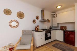 维也纳Cosy brand new Apartment的厨房配有白色橱柜和炉灶烤箱。
