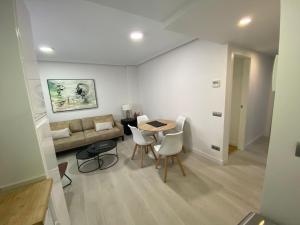 马德里包萨19号公寓的客厅配有沙发和桌椅