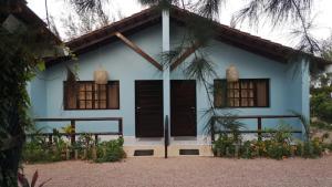 CatembeMoony’s Chalets & Camping的蓝色的房子,设有棕色的门和窗户