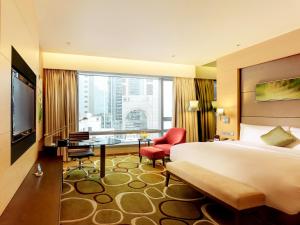 香港香港铜锣湾皇冠假日酒店的配有一张床、一张书桌和一扇窗户的酒店客房