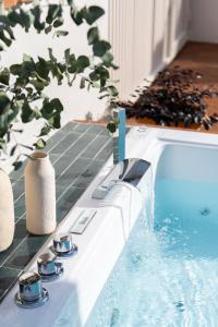 塞维利亚Magno Apartments Robles with Bath Tub and Private Parking的一个带桌子的游泳池,有杯子和植物