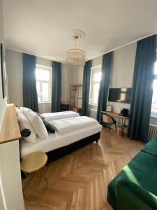 维也纳Boutique Hotel Kolbeck的卧室配有白色大床和蓝色窗帘