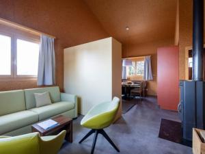 UrmeinHoliday Home Komfort Aclas Maiensäss Resort-1 by Interhome的客厅配有沙发和椅子