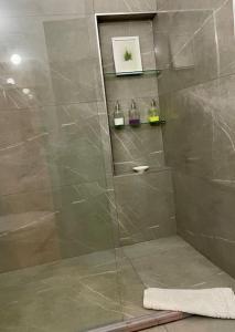 法马古斯塔Nicocreon Guest House的带淋浴的浴室和玻璃门