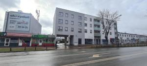 谢德尔采68 - Apartamenty Siedlce - Nowy apartament w centrum przy ul. 3 Maja 51a的一条空的城市街道,有白色的建筑