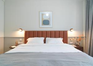 拉纳卡LIV The City Suites ADULTS ONLY的一间卧室配有一张带白色床单的大床