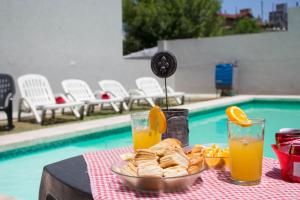 维拉卡洛斯帕兹Apart Porto del Sol by CPH的一张桌子,上面放着一盘糕点和两杯橙汁
