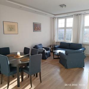 格但斯克Apartament Długa 35的客厅配有桌椅和沙发