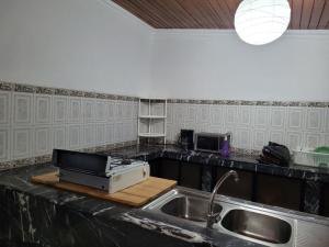 里奥班巴Casa de Mármol的厨房配有水槽和台面上的用具