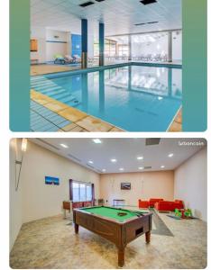 莱代塞尔Au bout du bois Piscine sauna hammam accessible en saison et le logement accessible toute l annee的大楼内带台球桌的大型游泳池