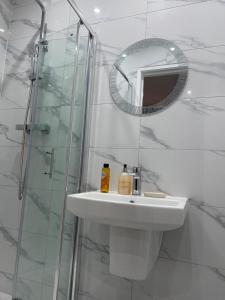 伊灵Belvue Serviced Apartment - Ealing Broadway的白色的浴室设有水槽和镜子