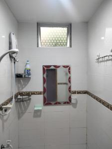 米里Taman Tunku Miri Budget Homestay的白色的浴室设有镜子和窗户