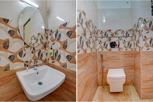班加罗尔FabHotel Greenwood Xpress的一间带水槽、卫生间和镜子的浴室